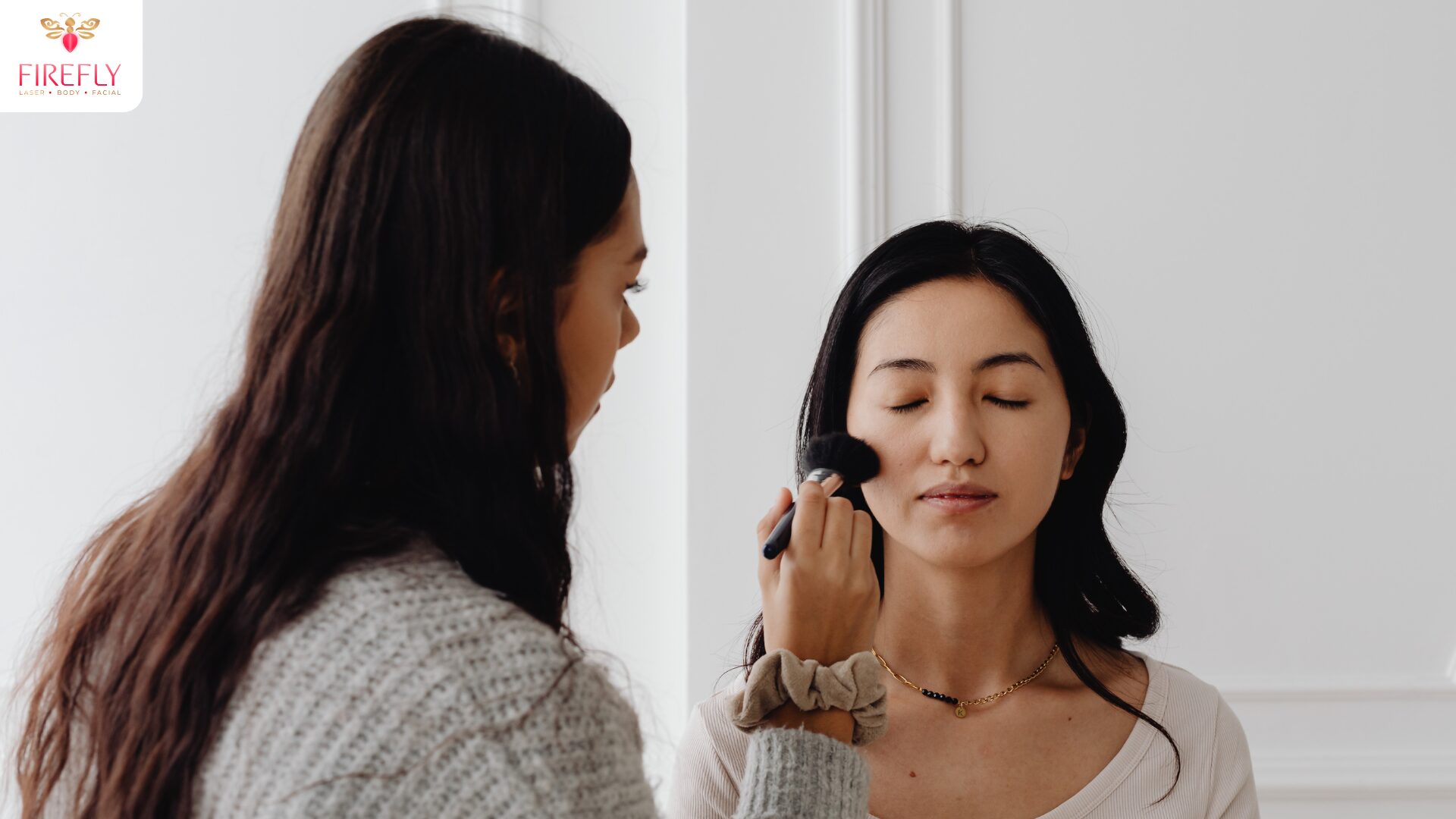 Light makeup application after facial using soft brush on clear skin